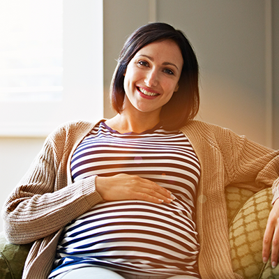 pregnant woman sitting and smiling