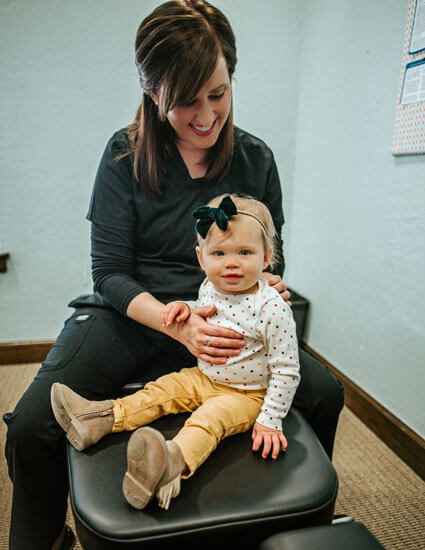 Dr. Shelton adjusting infant