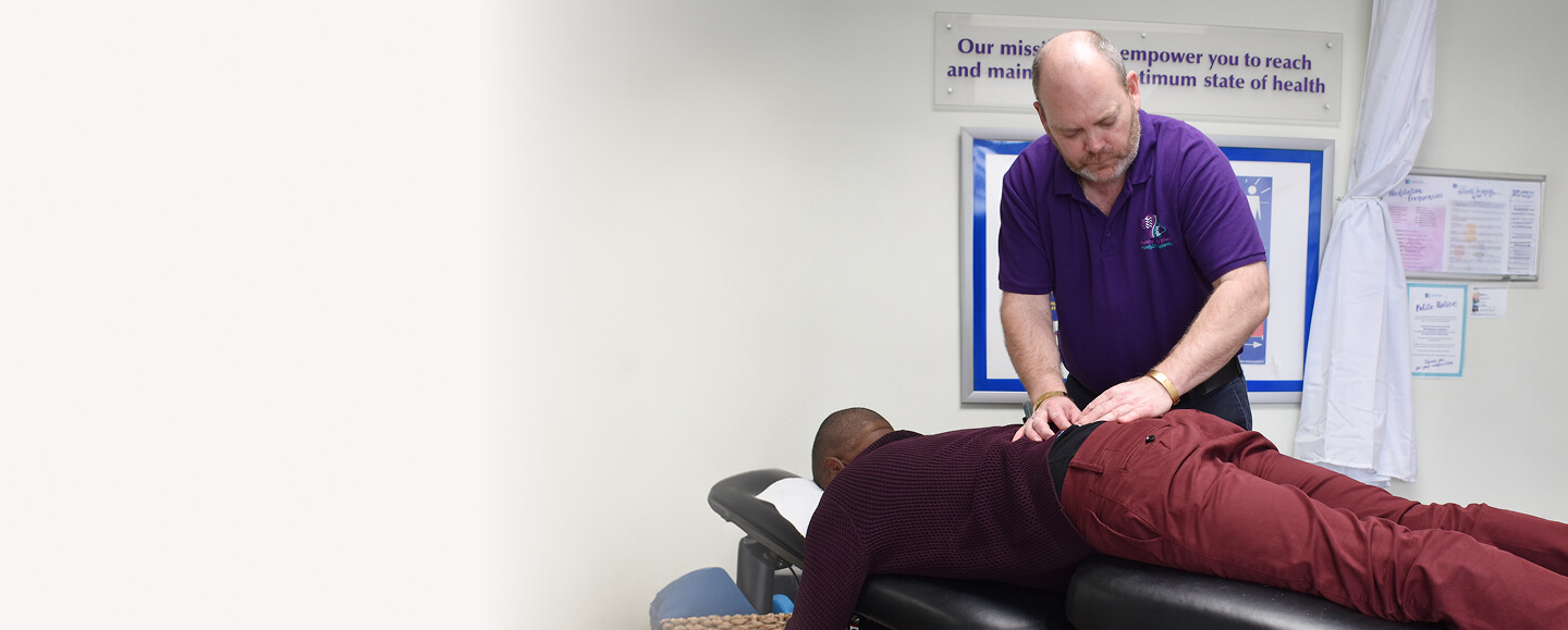 Chiropractor adjusting patient