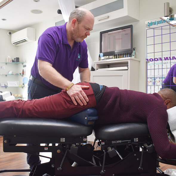 Chiropractor adjusting patient
