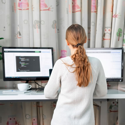 Girl standing while using computers