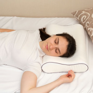 Woman sleeping on back with pillow