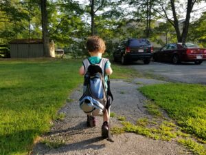 child wearing a backpack