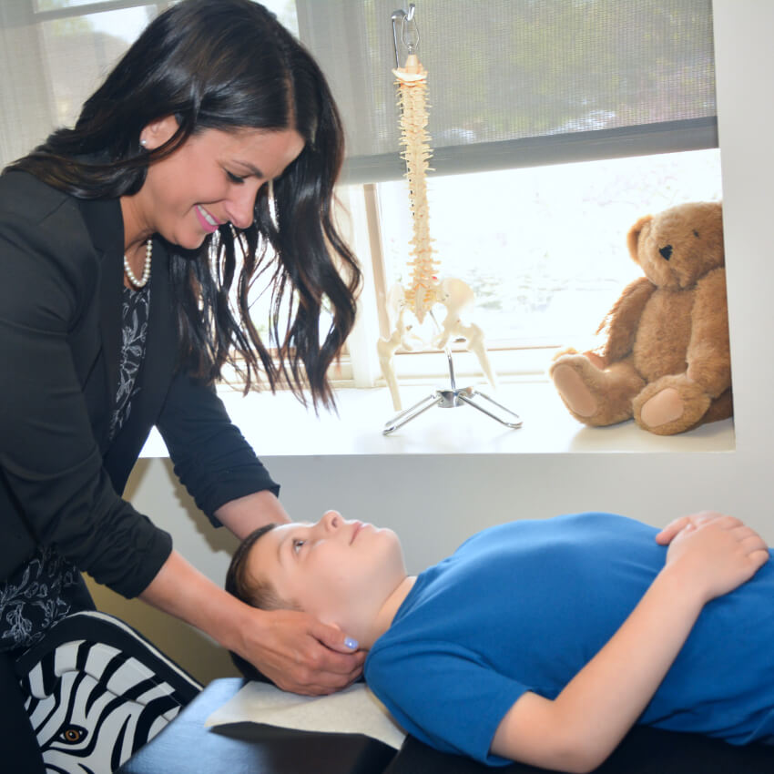 Dr Jessica adjusting childs neck