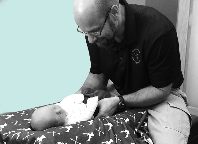 Dr. Terry adjusting baby