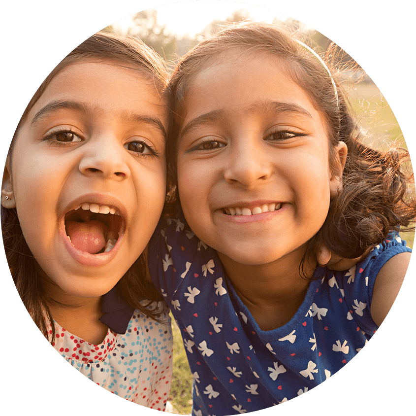 Little girls smiling in sun