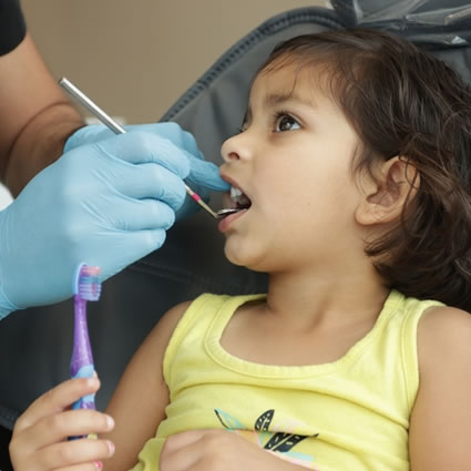 Doctor looking in little girls mouth