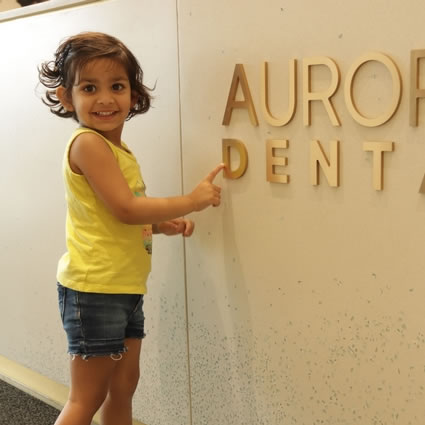 little girl pointing to office sign