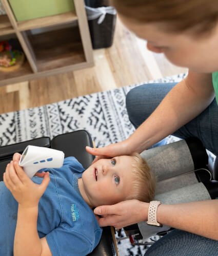 Chiropractor holding baby