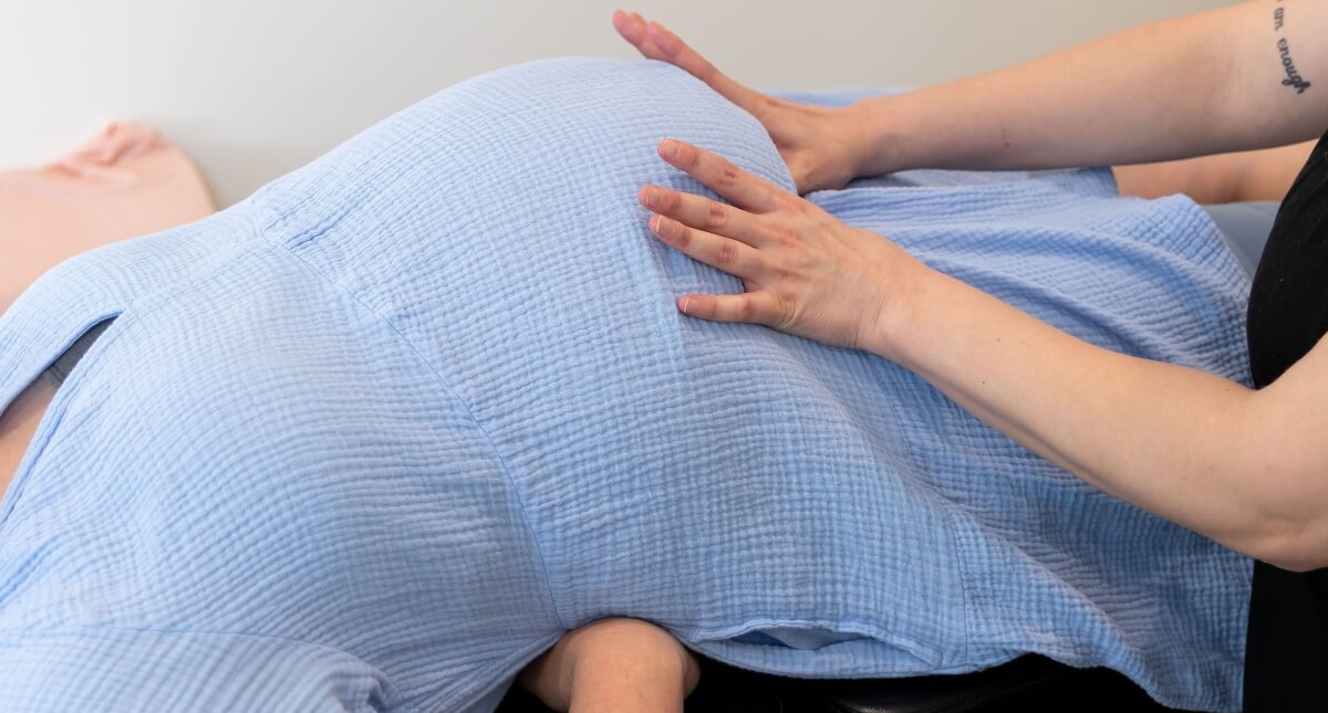 Heart hands on pregnant belly