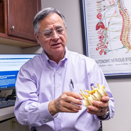 Dr. Rick holding spine model
