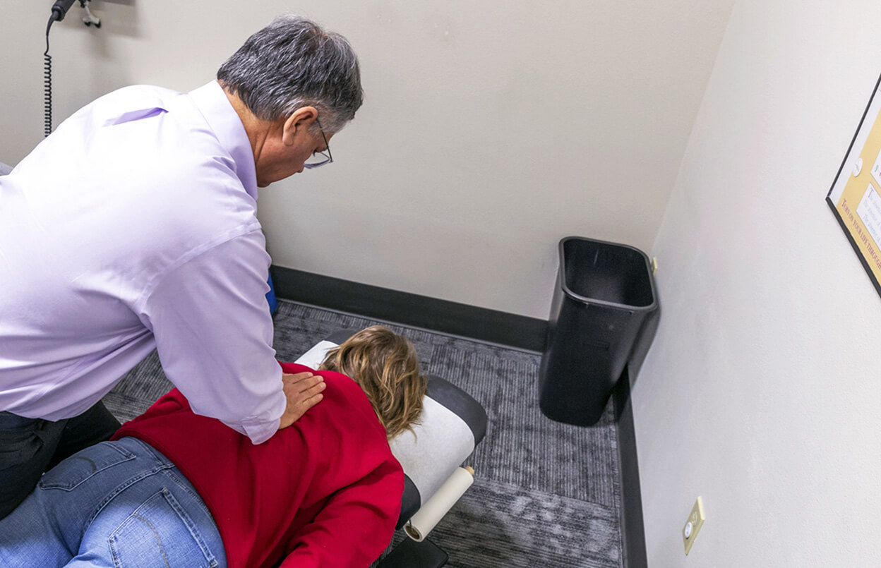 Dr. Longie adjusting woman's back