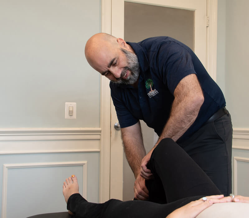 Alexandria chiropractor Dr Nick adjusting patients leg