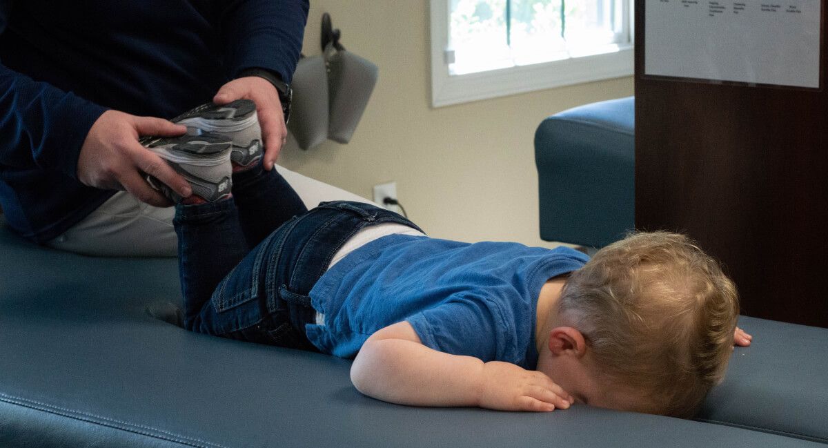 Chiropractor adjusting a toddler