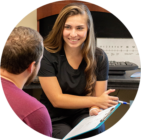 Staff with patient filling out paperwork