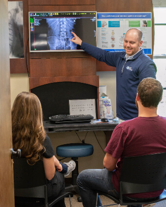 Kernersville chiropractor in consultation with patients
