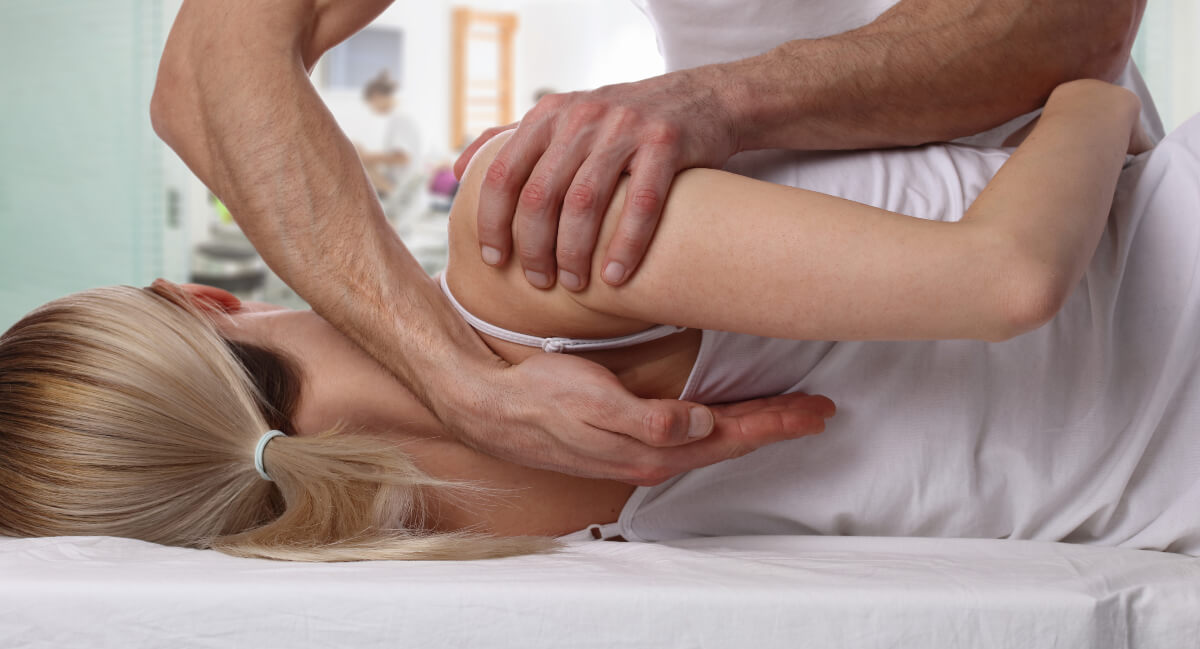 Chiropractor adjusting teenage patient
