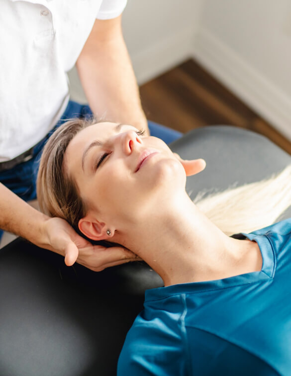 Female patient receiving a chiropractic neck adjustment
