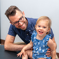 Chiropractor and child smiling