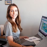 Receptionist smiling at computer