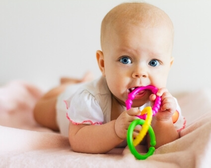 Baby with toy in mouth