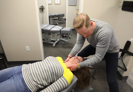 Doctor Cahill adjusting female patient