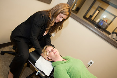 Dr. Darcey adjusting woman neck