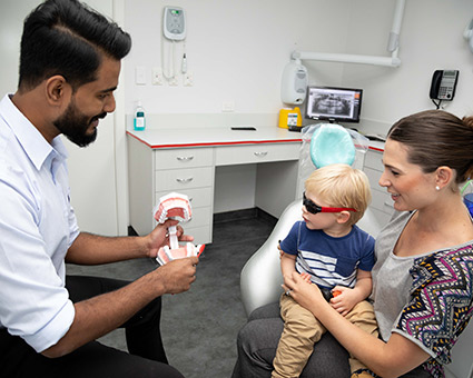 Dentist with toddler and mother