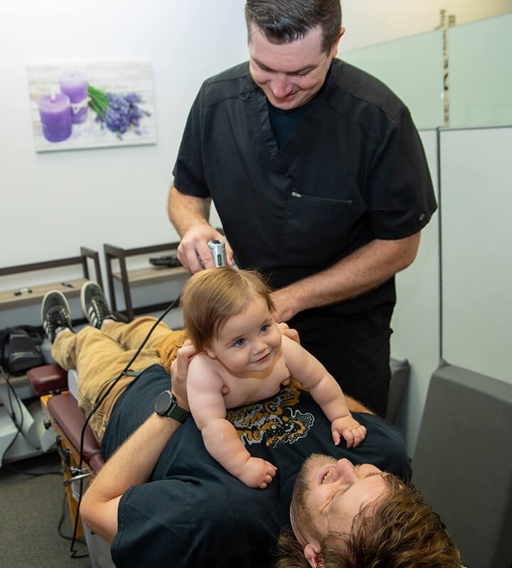 Dr. Nicholas Kirton adjusting a baby