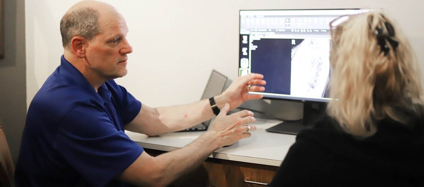 Inver Grove Heights chiropractor Dr. Scott Stinson in consultation with female patient