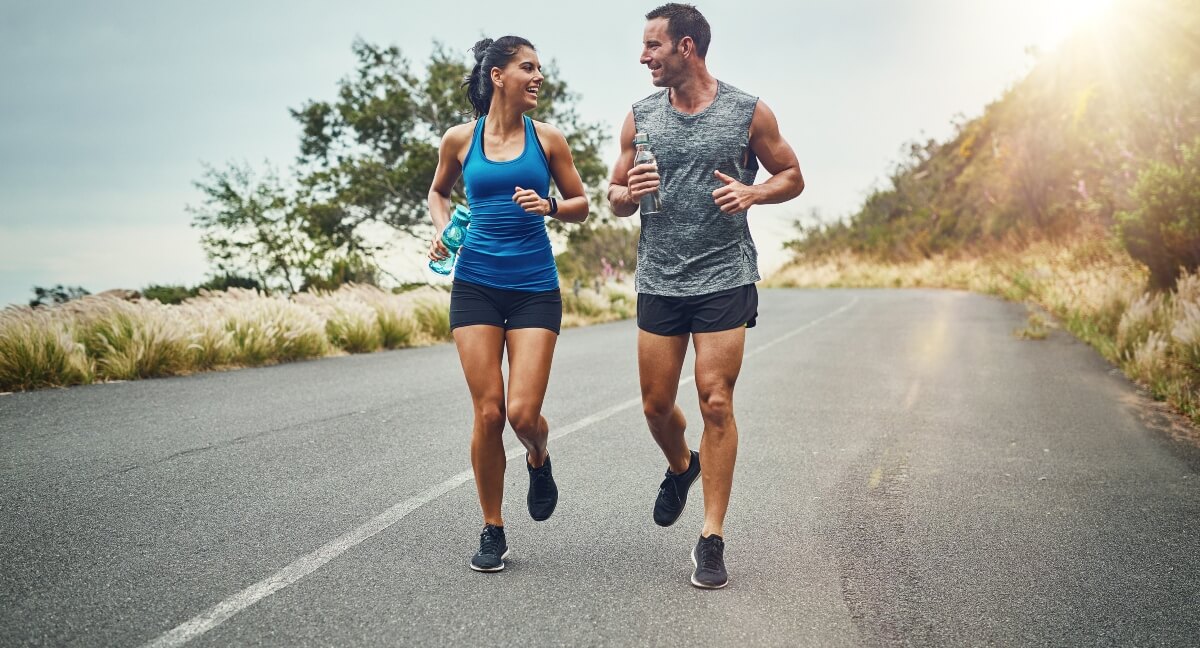 Man and woman running on a road