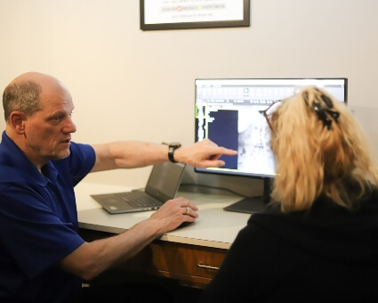 Inver Grove Heights chiropractor Dr. Scott Stinson in consultation with patient