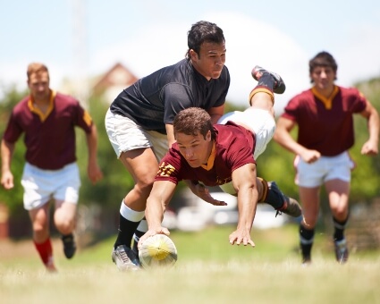 Young men playing rugby