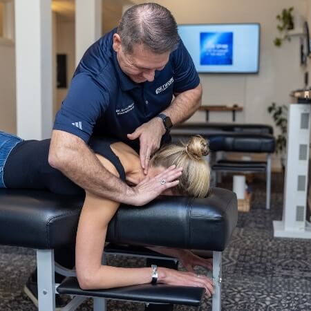 Male chiropractor adjusting a patient