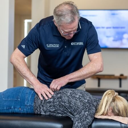 Female patient lower-back chiropractic adjustment