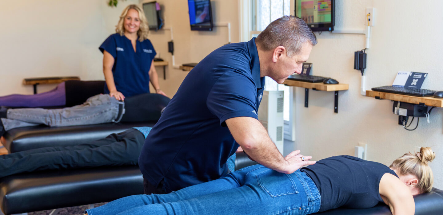 Chiropractor adjusting patient