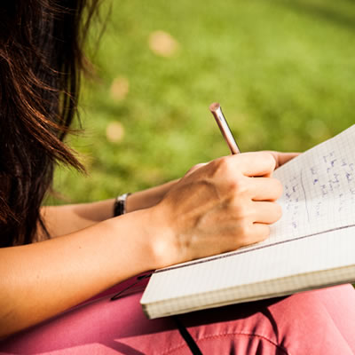 WOman writing in journal