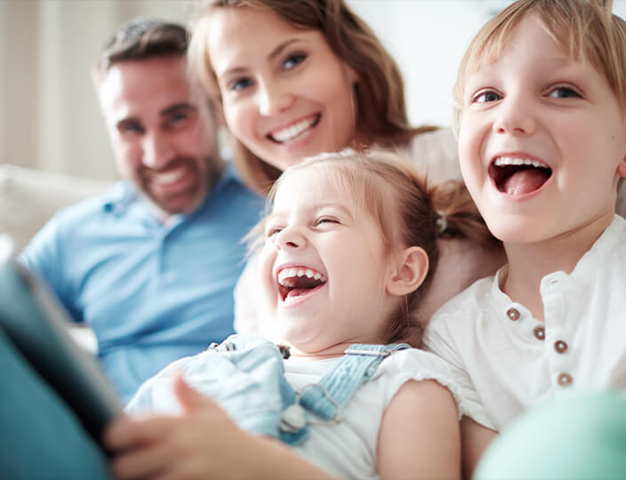 Family with 2 little girls laughing