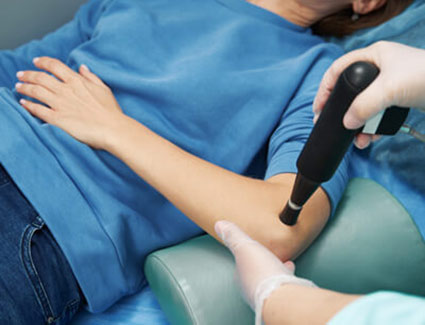 shockwave therapy on persons elbow