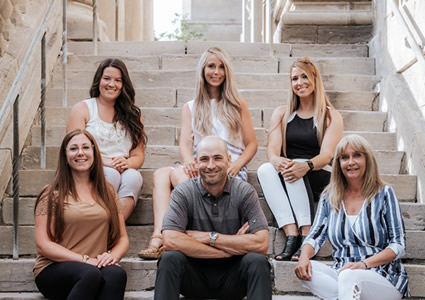 Niagara Spine and Sport Therapy team sitting on steps