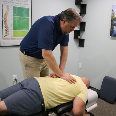 Evansville chiropractor adjusting a patient