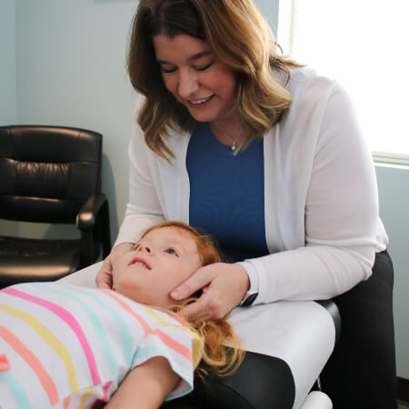 Evansville chiropractor adjusting a pediatric patient