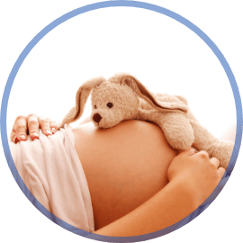 Pregnant woman with a stuffed animal on her stomach