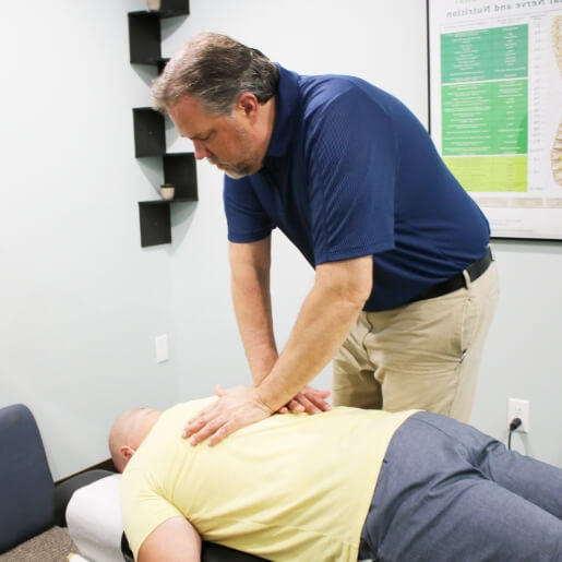 Evansville chiropractor adjusting a male patient