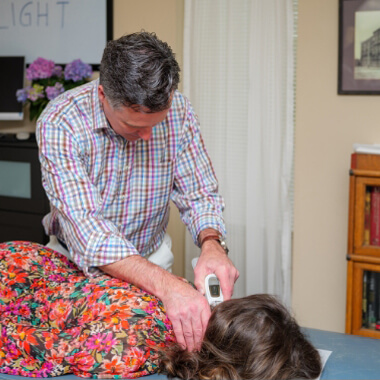 Woman getting adjusted with Activator