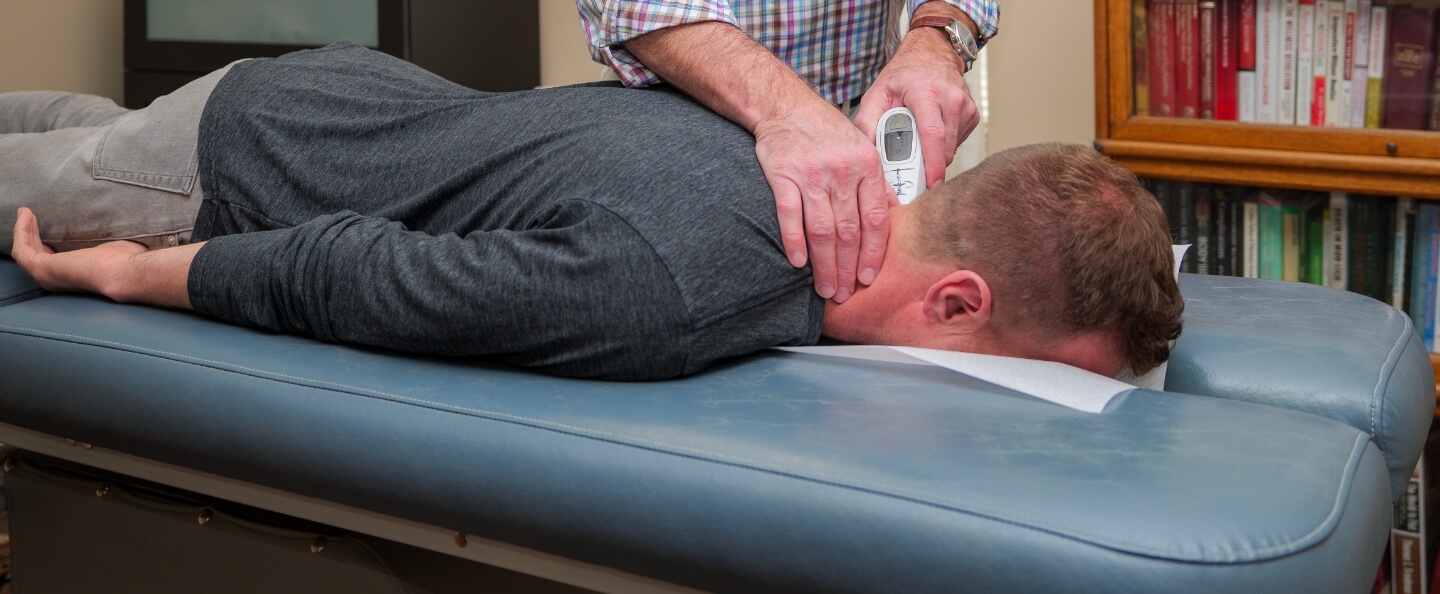 Dr. Marcus adjusting patient's neck
