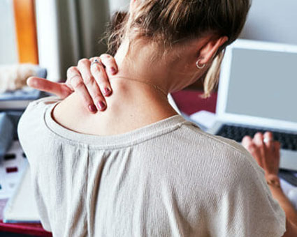 person at a computer with neck pain