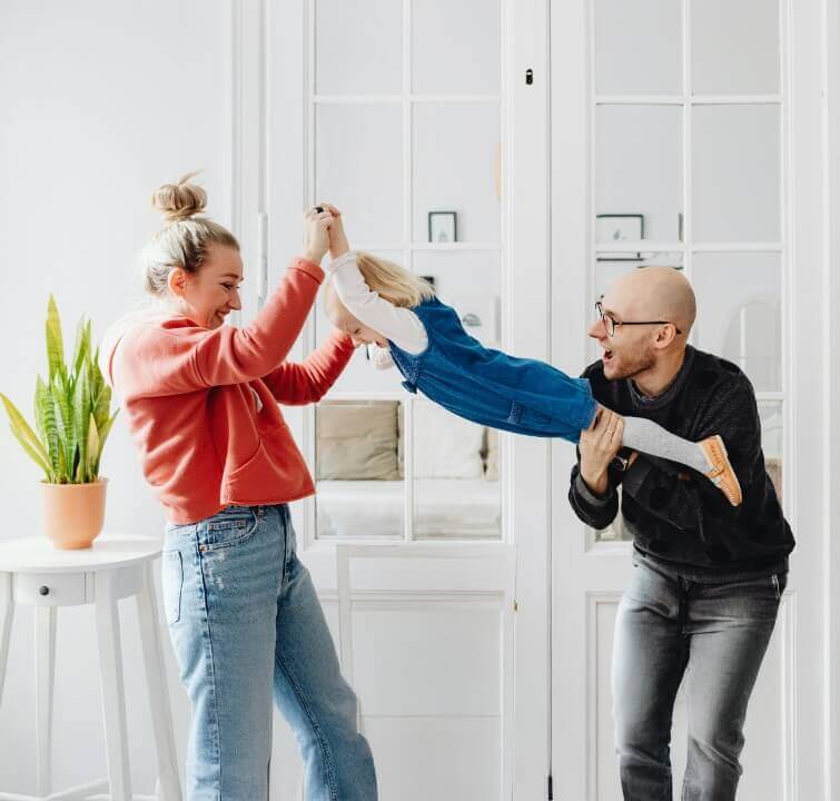 Mom and dad playing with young daughter