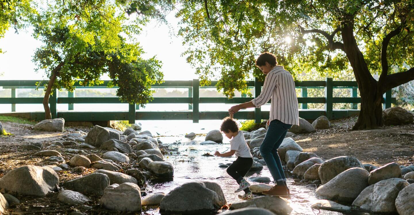 boy and mom walking across water