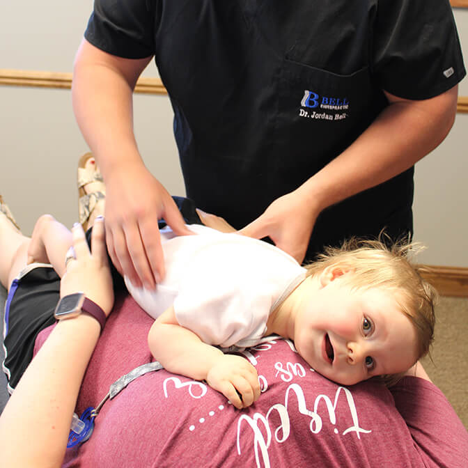 Dr Bell adjusting little girl's back